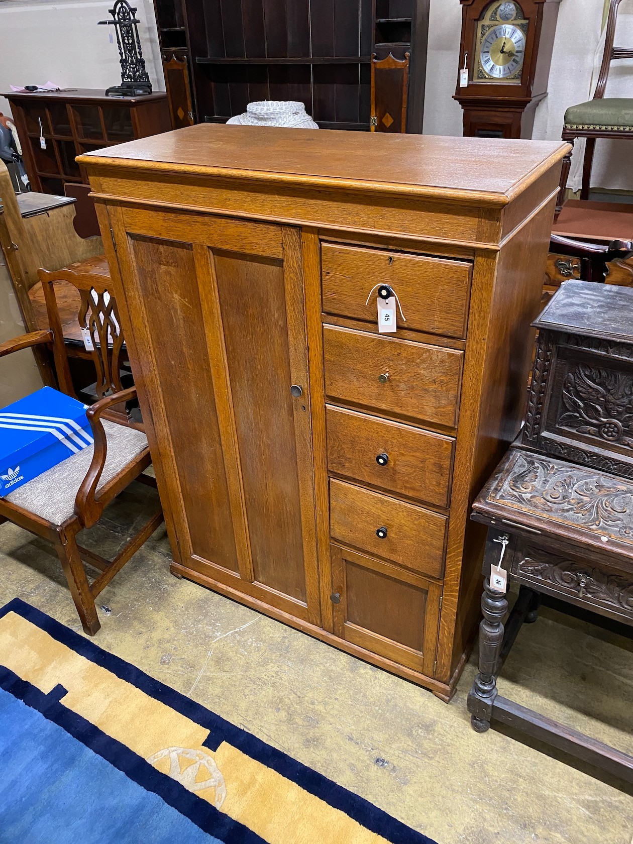 An early 20th century 'S.B.S.' furniture oak compactum with hinged mirrored top, width 102cm, depth 47cm, height 138cm